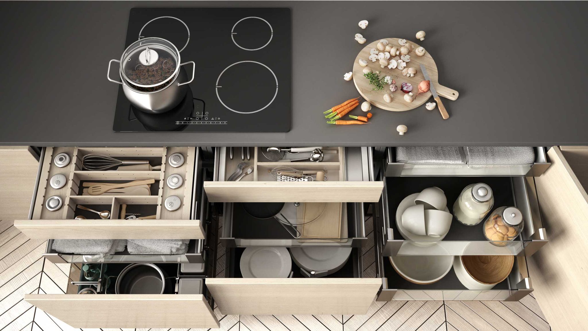 Top view of an organized kitchen with open drawers, a stovetop, and a cutting board with chopped vegetables.